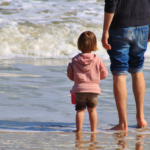 father and daughter spending time by the shore, seeking help with a chapter 39 case, paternity established in Florida